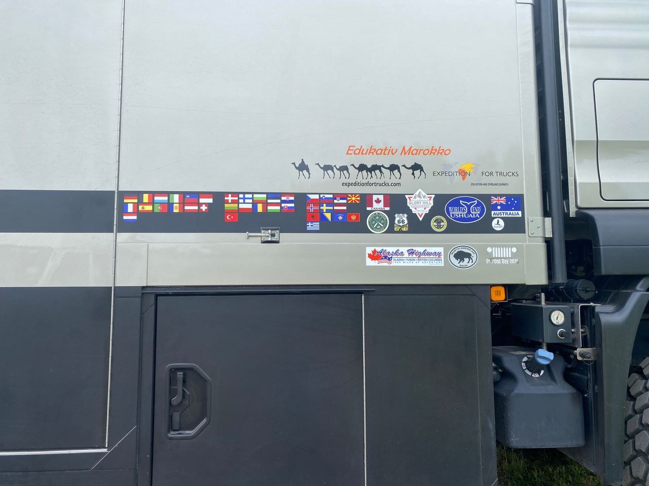 A German expedition camper with many country flag stickers